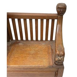 Victorian carved oak hall bench, raised shaped pediment carved with acorns and oak leaves, hinged lid over stick and umbrella stand with drip tray, fitted with a series of vertical rails, hinged and panelled box seat, carved with grotesque masks 