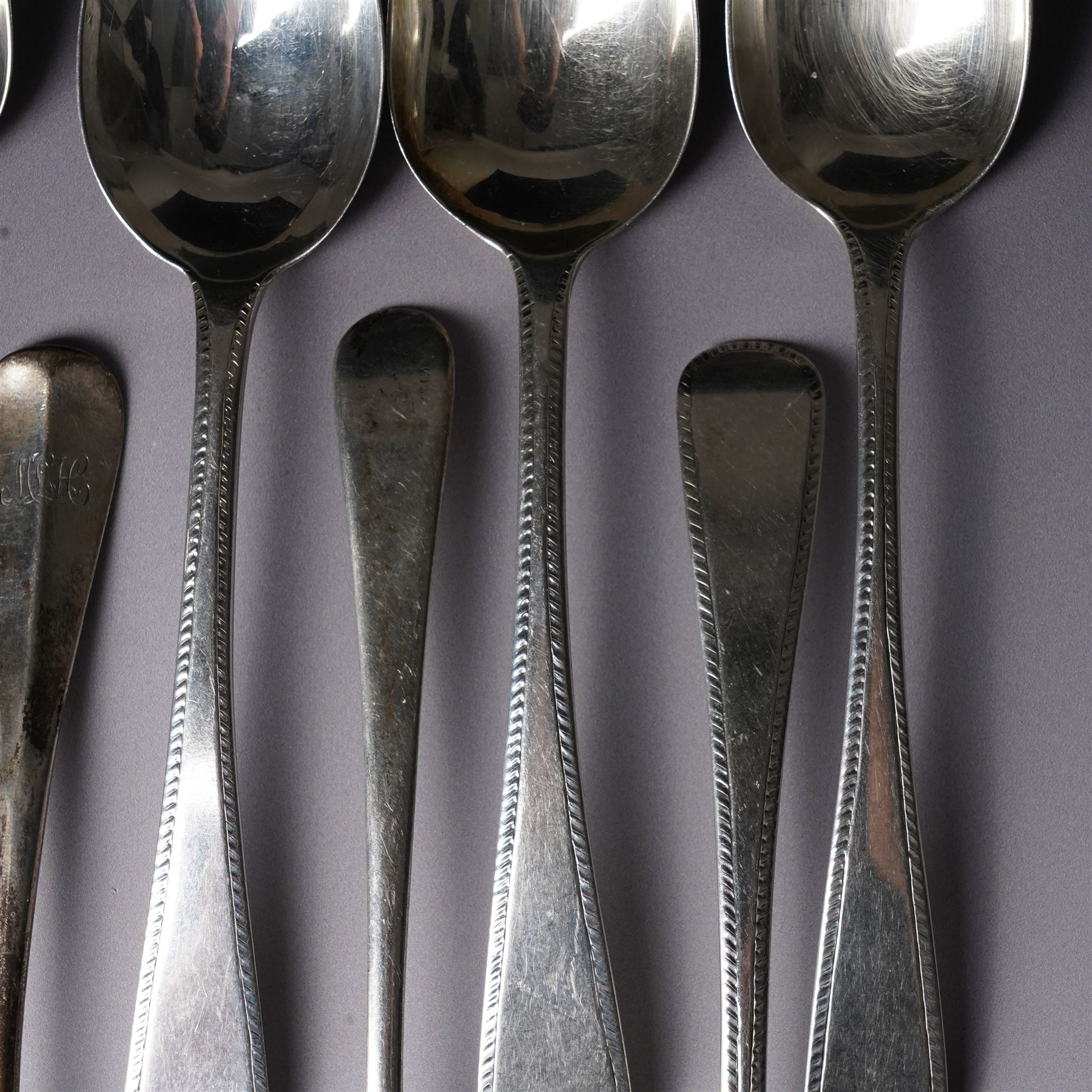Set of six George III silver dessert spoons with bright cut stemsLondon 1818 Maker Thomas Wallis II and Jonathan Hayne, three other silver dessert spoons and a silver berry spoon with gilded bowl (10)