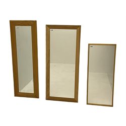 Two light oak framed wall mirrors, and a light wood rectangular wall mirror, the tallest - 140cm