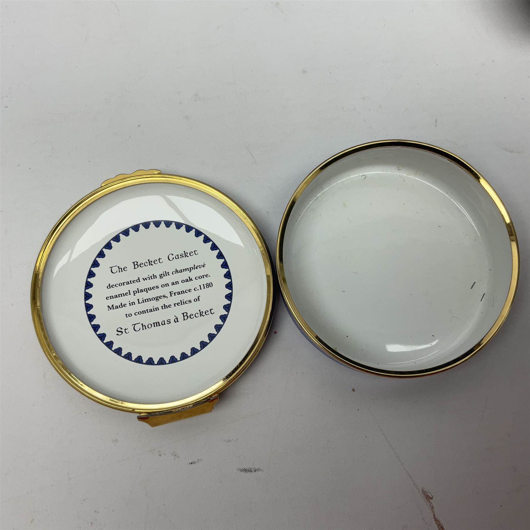 Halcyon Days bonbonniere, modelled as pink roses in a planter painted with a blue and white Japanese scene, together with five Halcyon Days enamel boxes, one a larger example depicting 'The Becket Casket' and four smaller boxes, including The 1993 Easter Egg, Happy Birthday and Statue of Liberty examples, all boxed, Becket Casket D8cm