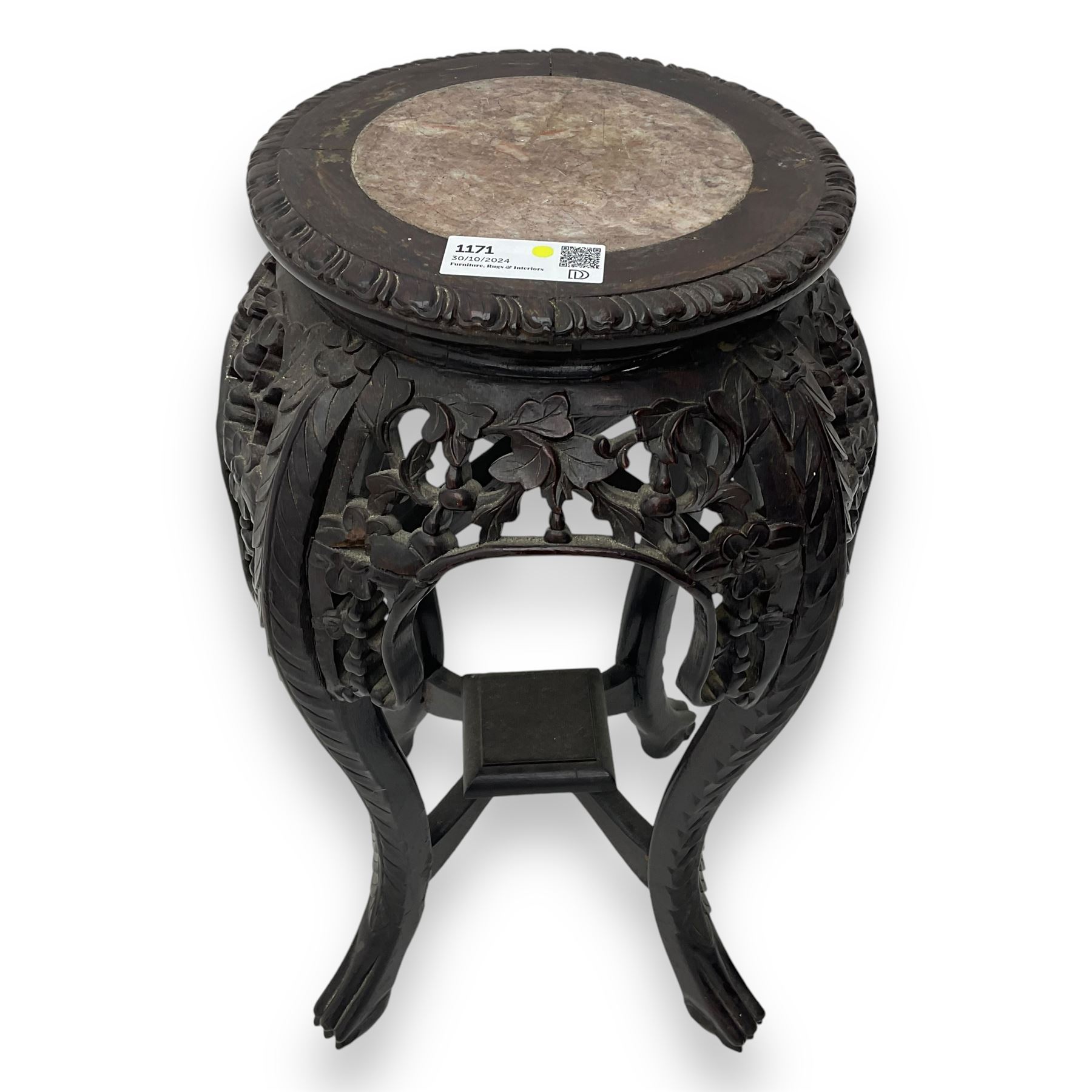 Late 19th century Chinese hardwood pedestal stand, circular top with inset marble panel, carved apron with openwork foliate and floral motifs, raised on cabriole supports with stylised claw and ball feet united by square undertier