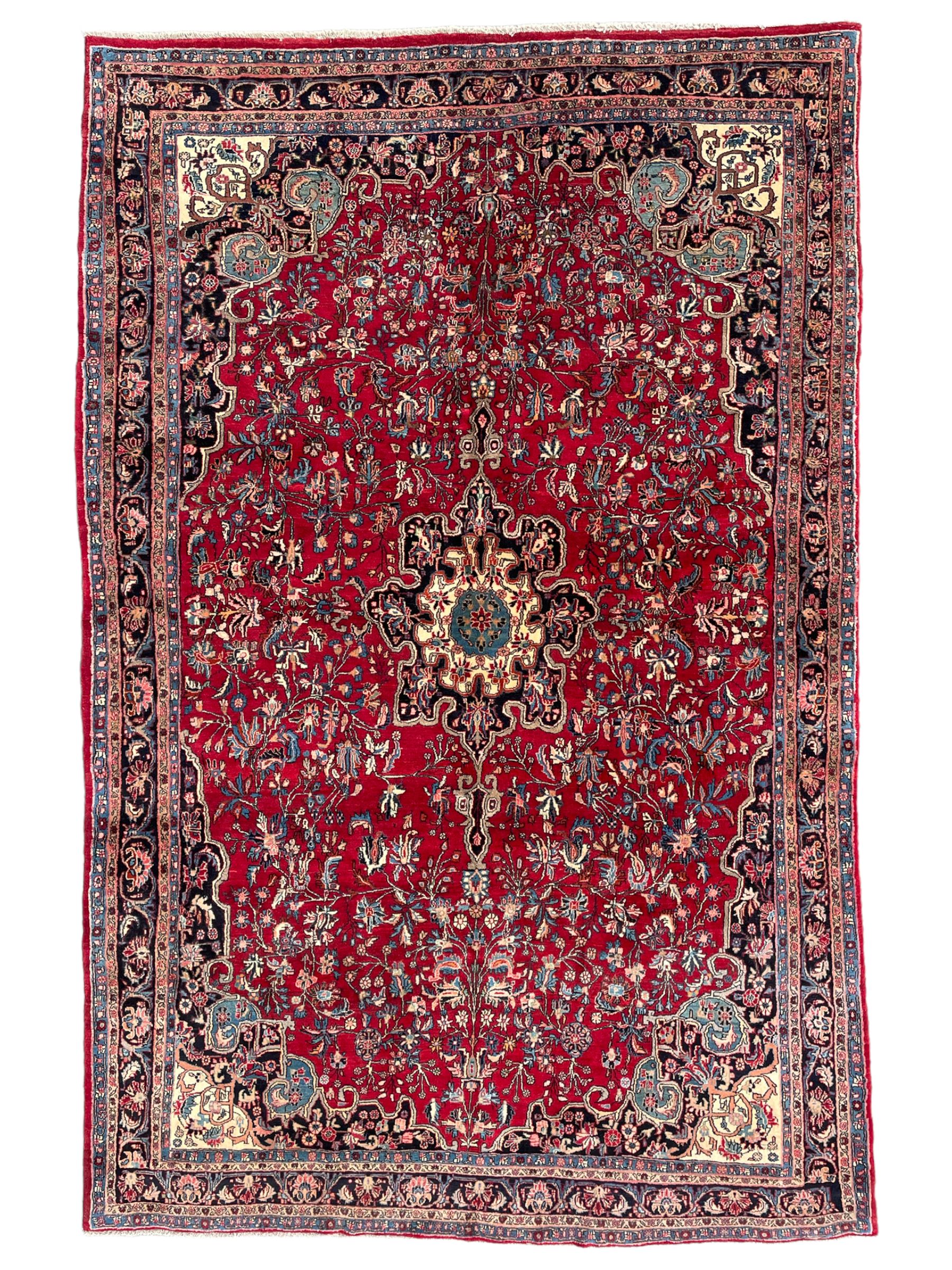 North West Persian Bidjar red ground carpet, shaped pole medallion surrounded by interlacing branches and stylised flower heads, five band border with repeating floral design