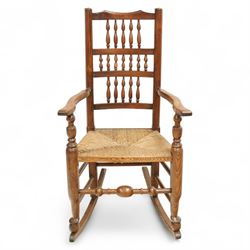 Lancashire elm rocking chair, shaped cresting rail over triple row bobbin turned spindles, woven rush seat, on curved rockers