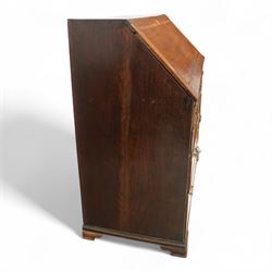 George III oak bureau, the fall front enclosing a fitted interior of small drawers and pigeonholes, above seven graduated drawers with brass plate handles and bone escutcheons, raised on bracket feet