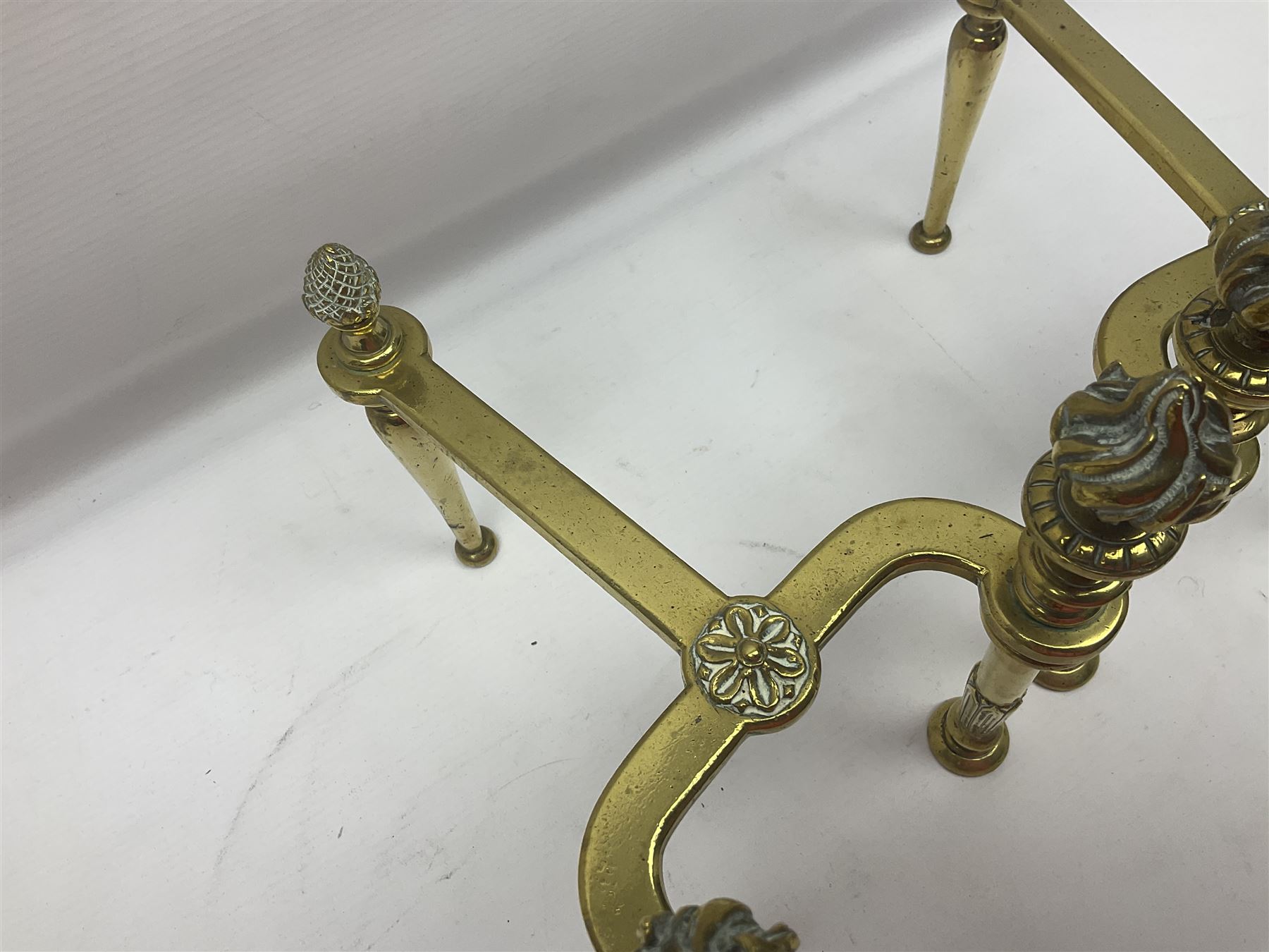 Early 20th century brass coal bucket with pierced sides, upon three pad feet, together with a pair of brass fire dogs, with flambe finials, coal bucket H27cm