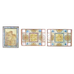 Two stained glass leaded panels each decorated with birds in foliate to to the centre, tog...