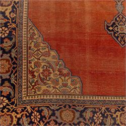 North West Persian Tabriz hand-knotted carpet, salmon field with central elongated lozenge medallion intricately filled with scrolling arabesques and palmettes, framed by stylized corner spandrels within a broad indigo main border  of bold palmettes and floral vinery between multiple guard stripes, rendered in tones of terracotta, sage green, and soft ivory, with cotton fringe ends 