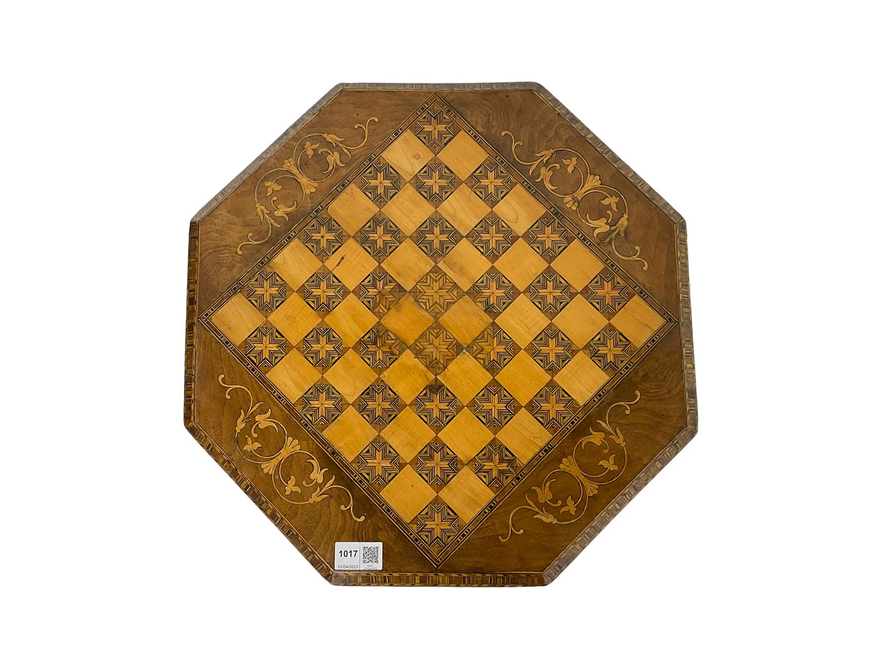 Late 19th century inlaid walnut sewing or work table, octagonal hinged top with satinwood and ebony chessboard inlay, surrounded by foliate decoration, the edges inlaid with crossbanding and stringing, fitted interior with chess pieces, raised on baluster pedestal carved with acanthus leaves on a tripod base 