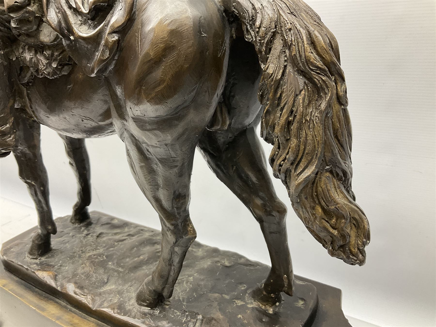 Large and impressive bronze figure of Wellington seated on a horse, on a sarcophogus shaped stepped base impressed 'Meunier Paris', the canted corners inset with battle trophies H68cm L50cm D22cm