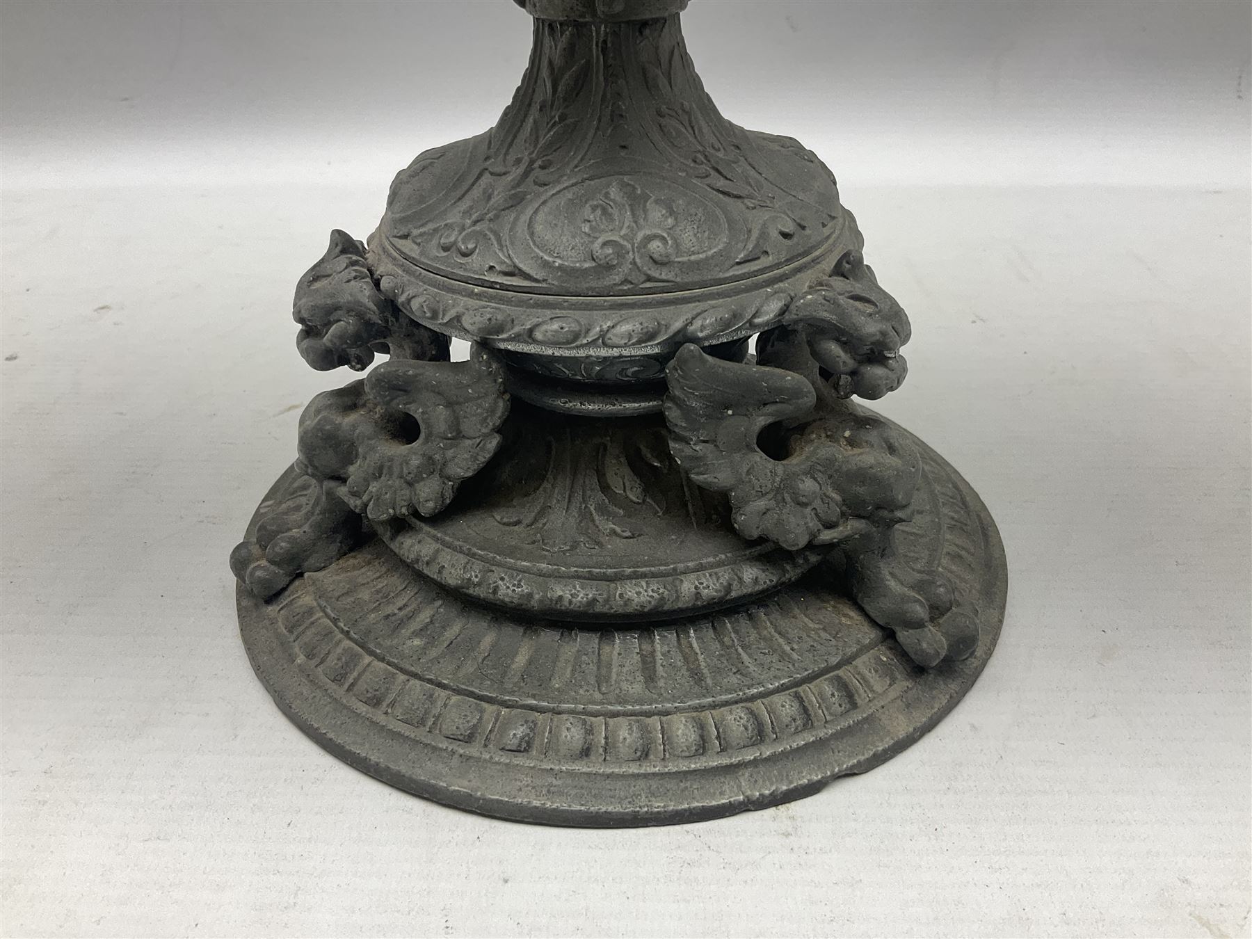 Victorian cast spelter oil lamp, decorated with cherubs and foliate scrolls, supporting a glass reservoir, burner and clear glass chimney, H62cm