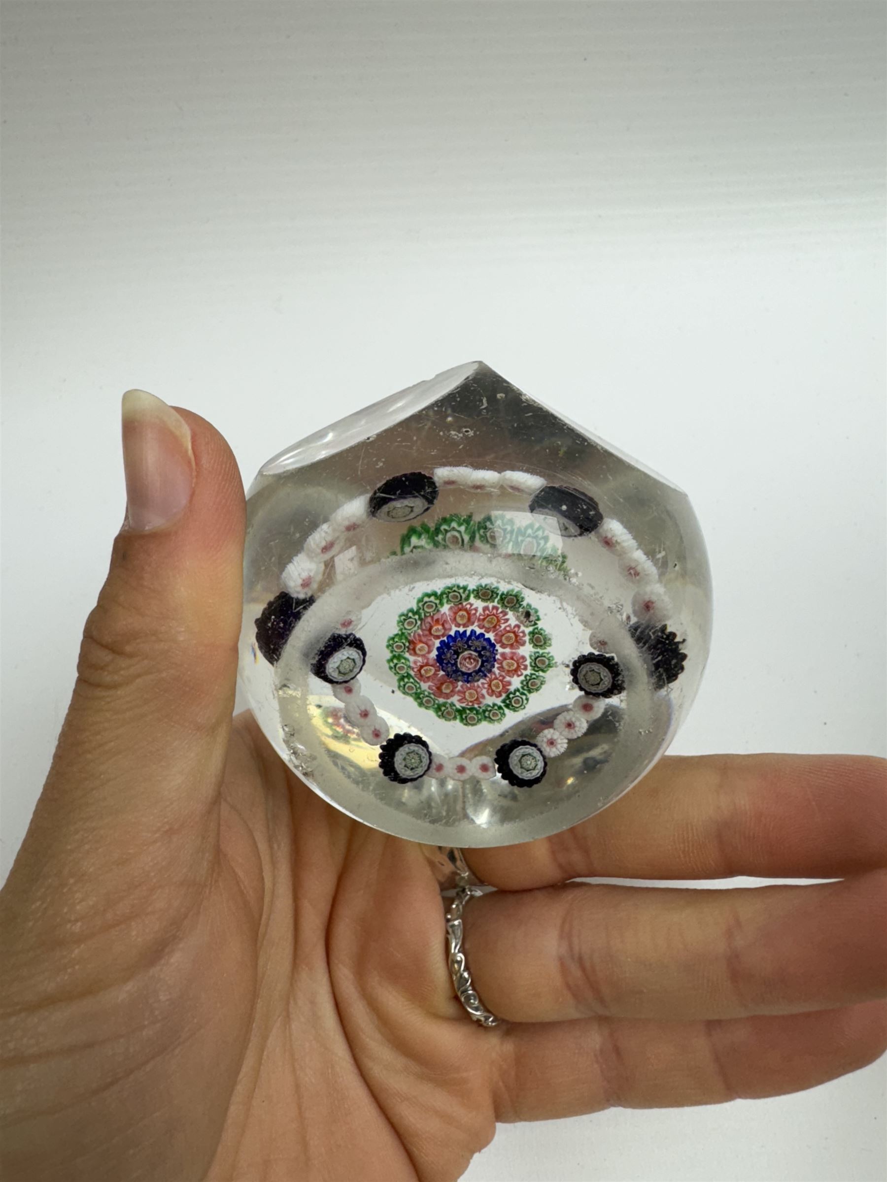 Glass Millefiori paperweight of hexagonal faceted form, H5cm