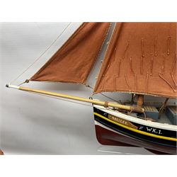 Wooden model of the Peterhead Herring Fishing Boat, Love Divine, PD404. on stand together with Wick Herring Fishing Boat, Galilee WK.1. on stand, L105cm, H64cm