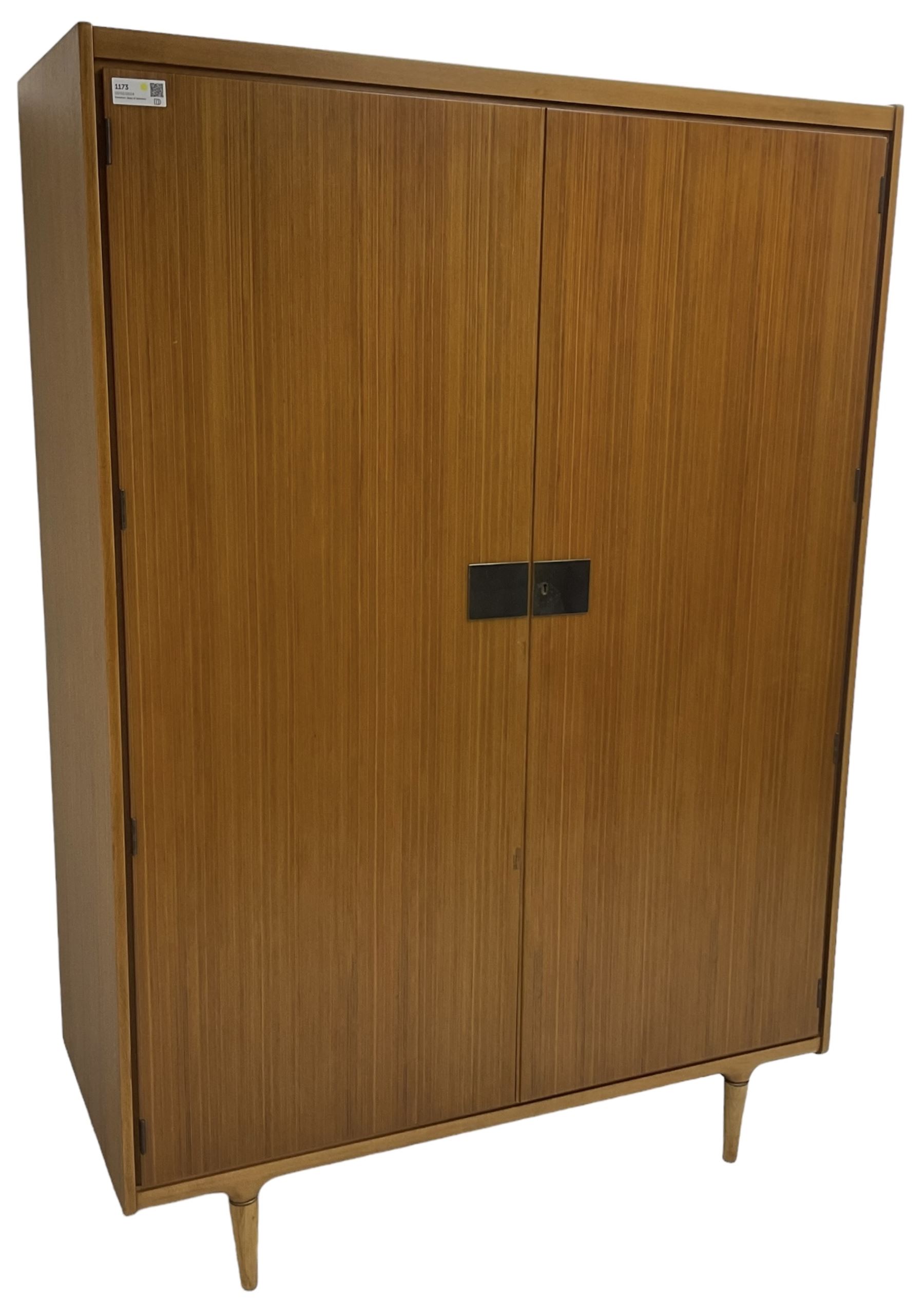 Wrighton - mid-20th century teak wardrobe, two doors enclosing hanging rail, shelves and hinged compartments, on turned tapering feet