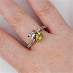 9ct white gold quartz, aquamarine and diamond crossover ring, single pear cut aquamarine and yellow / green quartz, with diamond set shoulders, Birmingham 2004