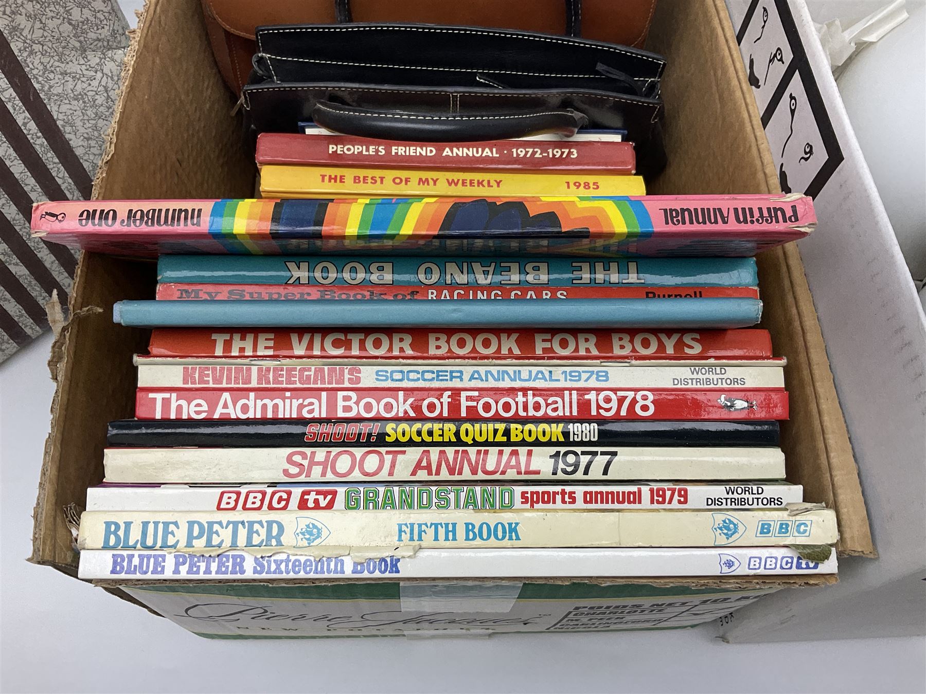 Collection of silver plated cased cutlery including part canteens and butter knives, together with other metal ware including J&J Siddons iron, horse brasses and a copper kettle, 1970s children's annuals including Beano, two handbags and three suitcases, vintage tins etc, in four boxes 