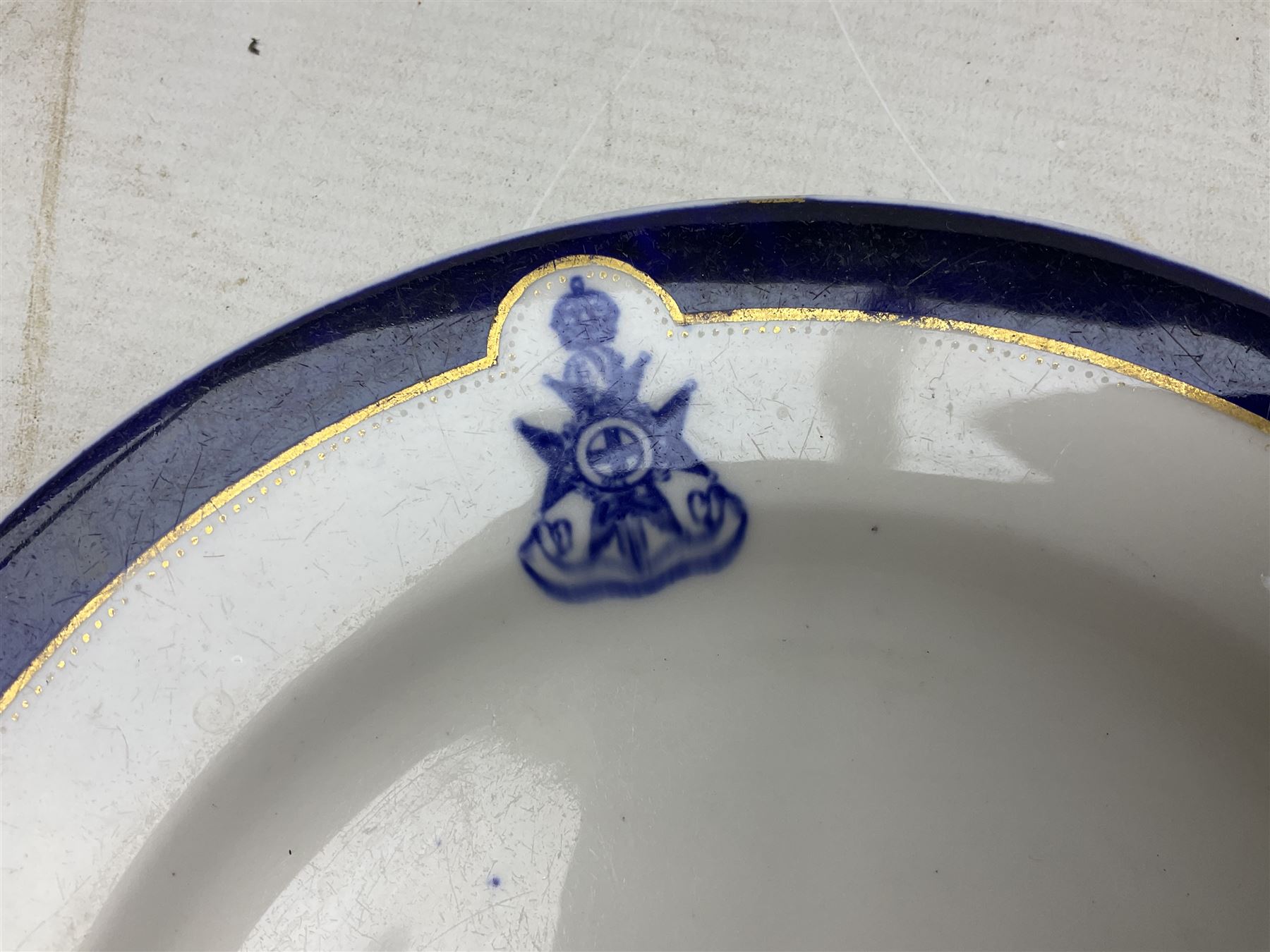 Collection of Regimental dinner wares, Comprising Royal Sussex; two dinner plates, two side plates and a soup bowl, Royal Leicestershire; two dinner plates, East Yorkshire Regiment side plate and Gordon Highlanders side plate, all decorated with the regiment's crests and blue and gilt boarders (9)