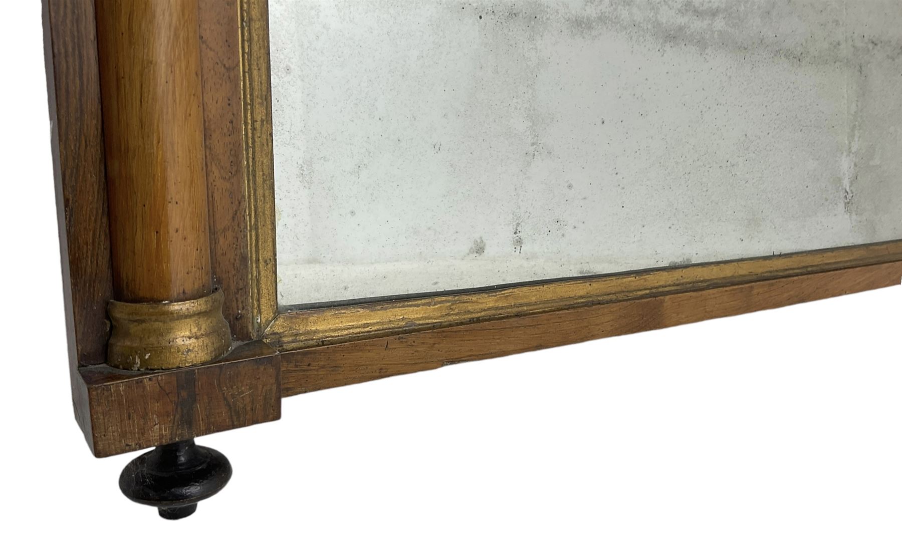 Early 19th century rosewood overmantel mirror, rectangular form with turned half pilasters, moulded gilt slip enclosing plain mirror plate, on turned feet