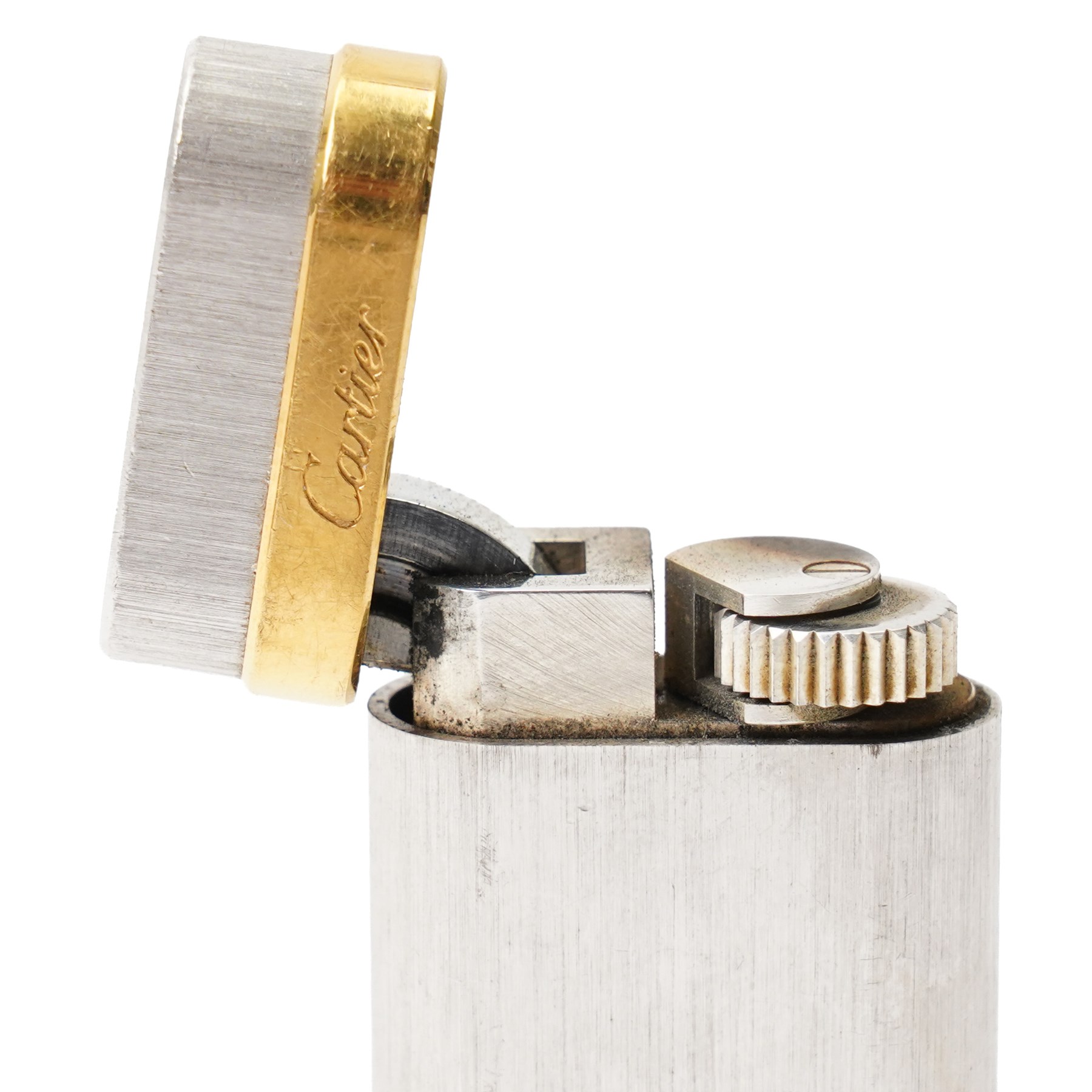 Cartier - silver-tone and gold-tone pocket lighter, with brushed vertical finish, hinged cover and gold-tone band signed Cartier, base signed Cartier and numbered, with original fitted presentation box, outer box and international guarantee booklet
