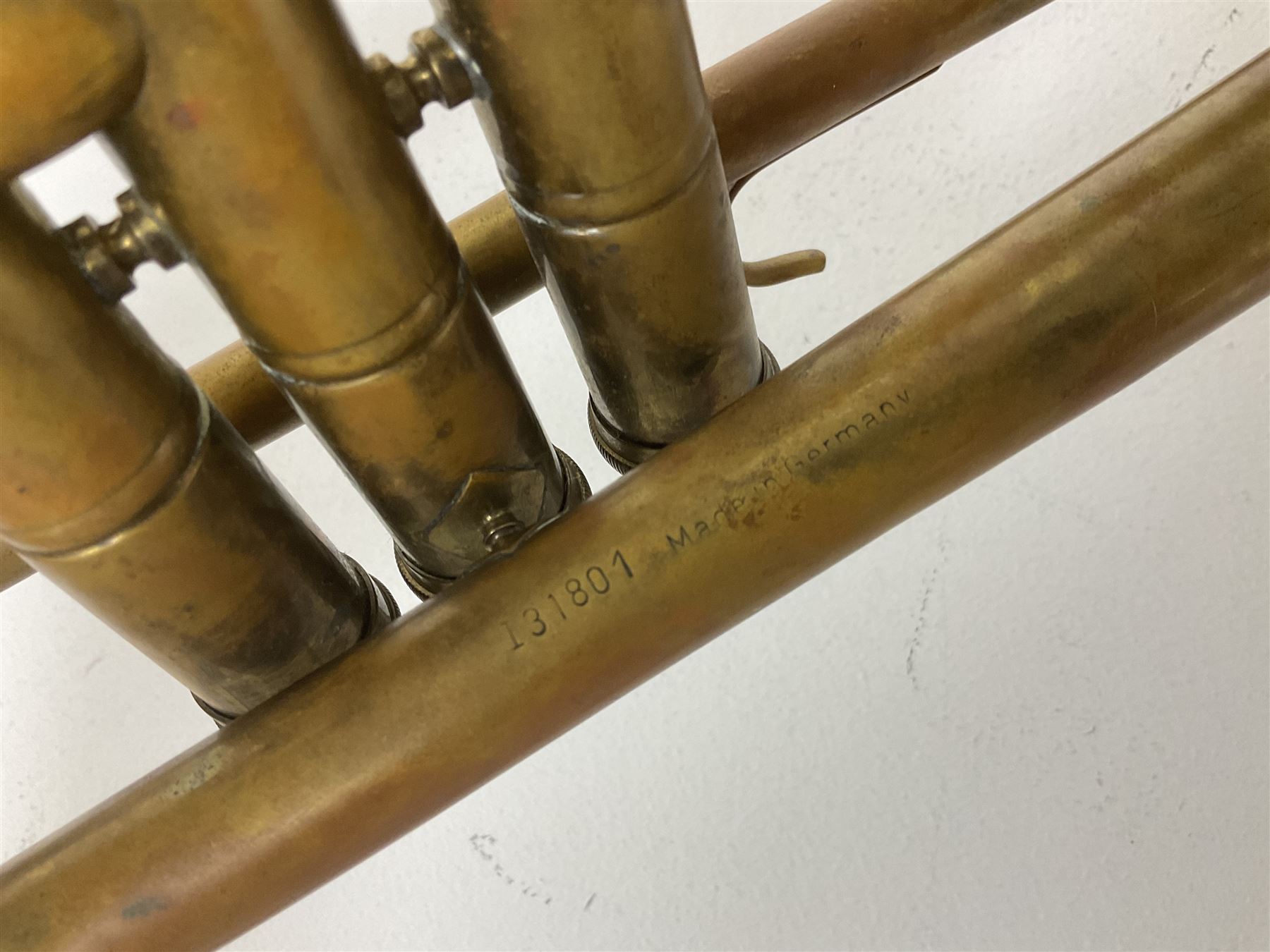 Three brass trombones comprising Elkhart Ind. USA 'CONN' model no.72H; Besson 'Concord'; and Selmer Distributed 'Lincoln'; two in carrying cases; and German B & M 'Champion' brass trumpet (4)