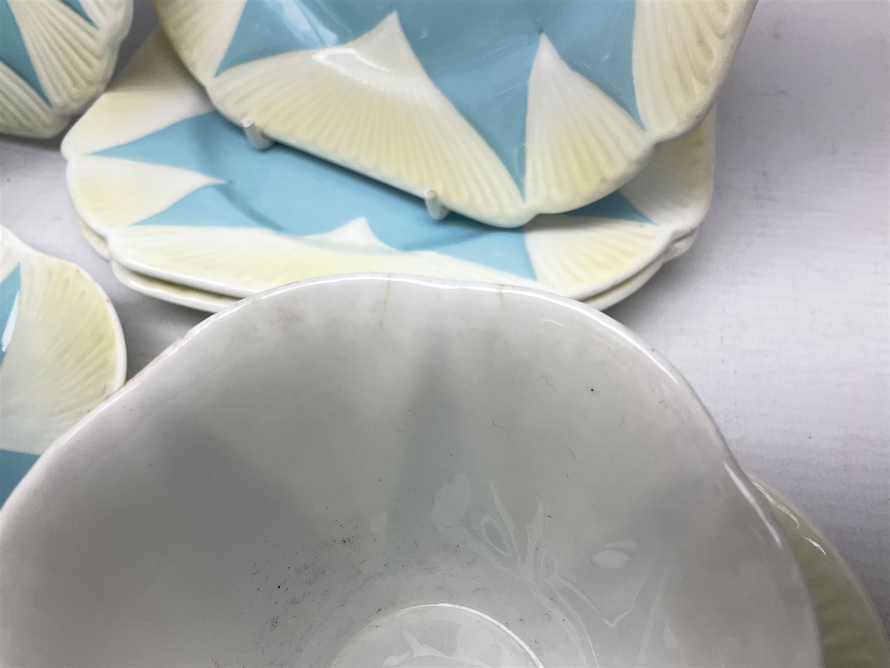 Shelley Dainty pattern tea wares, of lobed form with blue star decoration on merging white and yellow ground, comprising five teacups, five saucers, six tea plates, milk jug and cake plate, all with printed green mark beneath, some with painted pattern no 11770