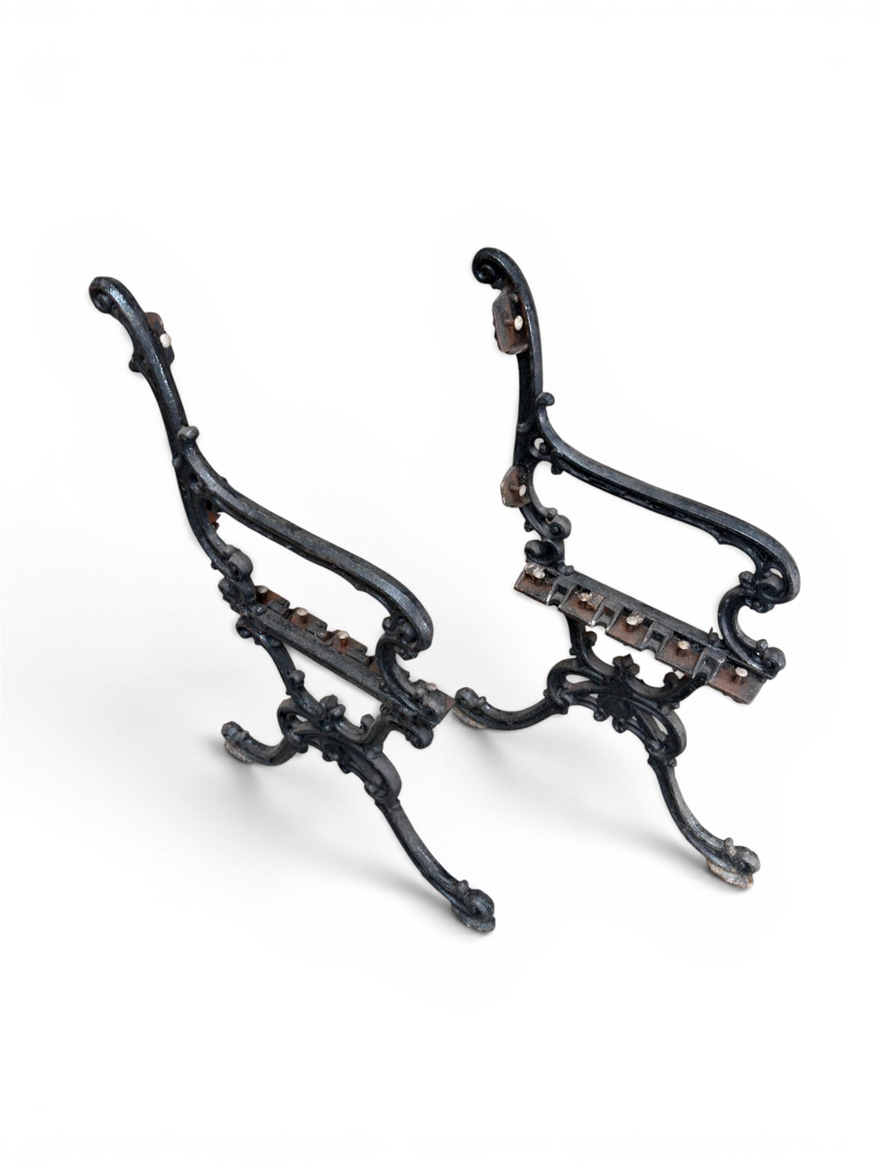 Carron Foundry - two pairs of 19th century cast iron garden bench ends, ornate detail with arms and X shaped legs,finish in black paint, the design no. 110396, first registered 13 July 1857 (see illustration), width as desired