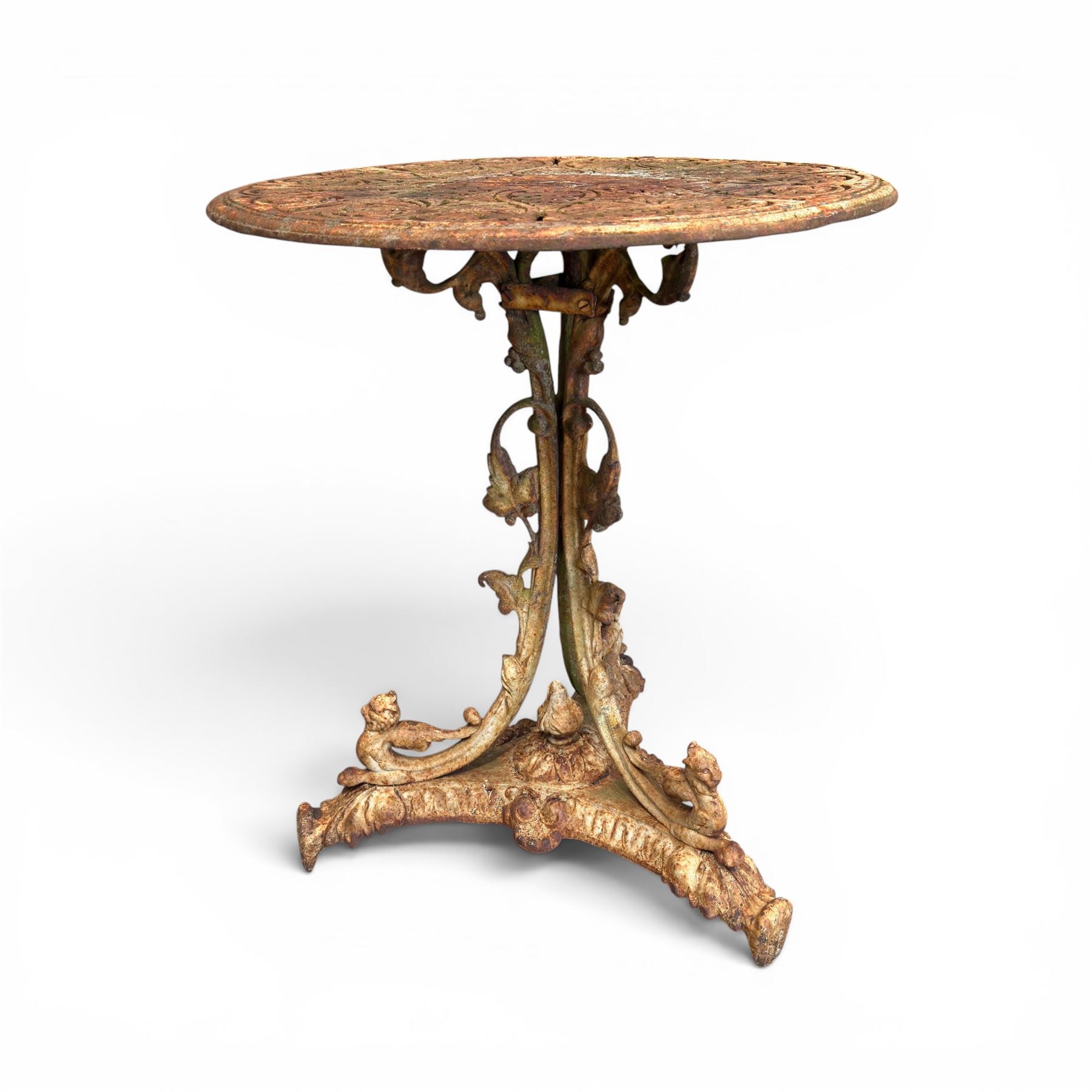 Victorian cast iron garden table, circular pierced top with foliate and scroll decoration, raised on an ornate tripod base with natural weathered paint finish.