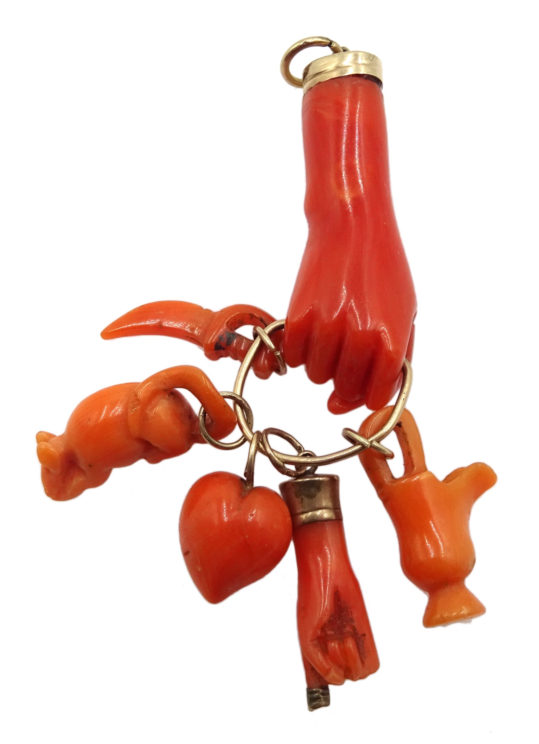 Victorian gold carved coral hand charm holding a heart, hand, jug, sword and mouse