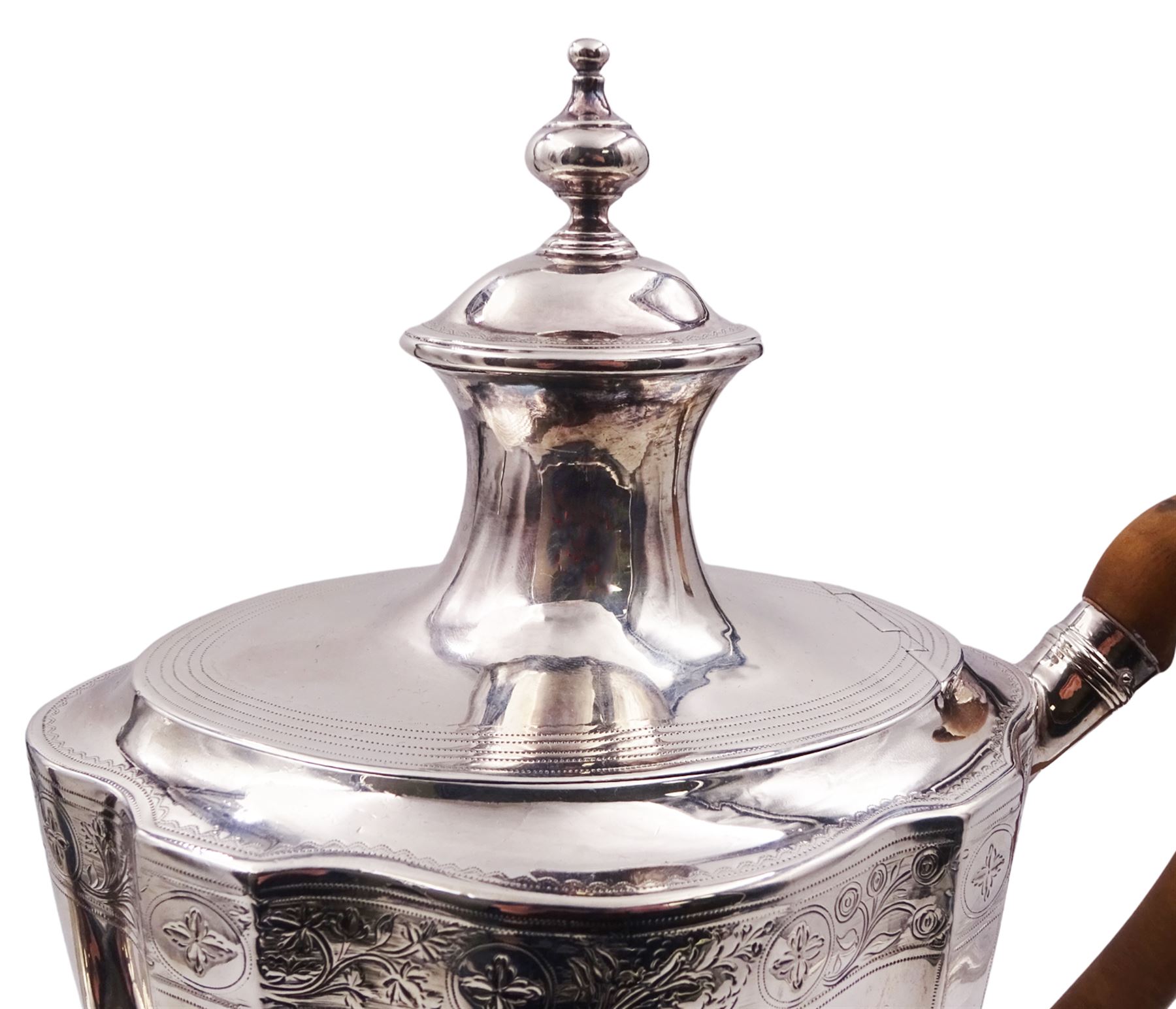 George III silver coffee pot, of vase form with part faceted sides and wooden scroll capped handle, the body engraved with central crest and finial border, hallmarked London 1796, makers mark partly worn and indistinct, H29.5cm, approximate gross weight 25.53 ozt (794.3 grams)