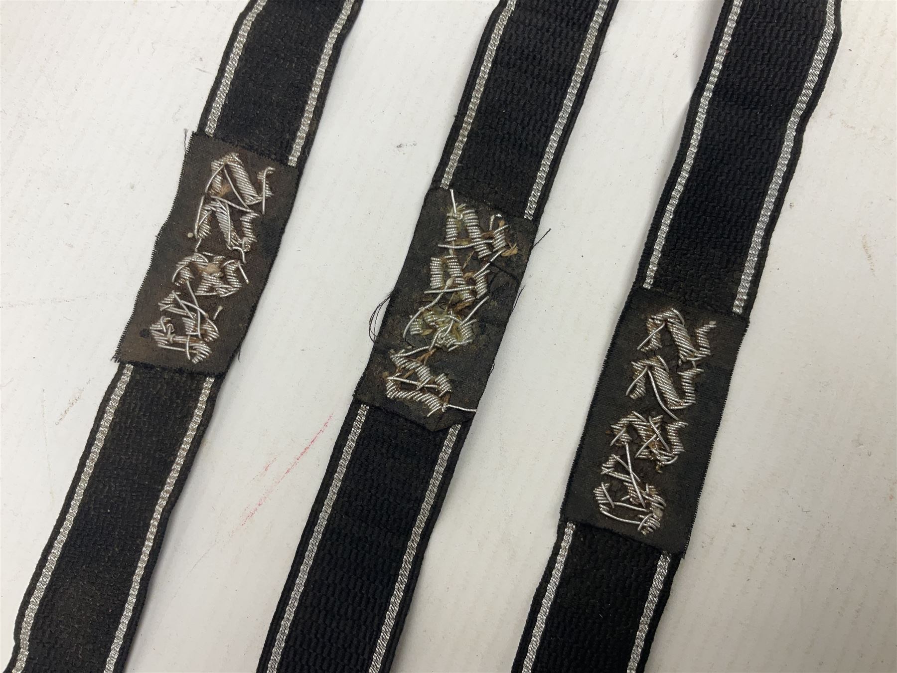 Three Reichsfuhrer 'SS' cuff titles; RZM 'SS' paper tag; German Water Police belt buckle; Destroyers badge marked RKS verso; N.S.B.O. lapel badge; and incomplete party eagle cap badge (8)