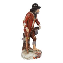 Mid 18th century Furstenberg figure, modelled as a beggar or mendicant with peg leg and bare foot, circa 1755, modelled by Simon Feilner, wearing tattered clothes, one arm supporting an alms pouch, the other holding a crutch, upon a part scrolled base, bearing paper labels beneath including one inscribed 'Sammlung Wilhelm Gumprecht 322', H15cm
