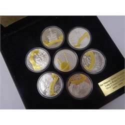  Seven Queen Elizabeth II silver proof five pound coins, six being from the 'Long to Reign Over Us' silver crown collection and a 'Sapphire Coronation Jubilee Coin', all with certificates, in a display case  