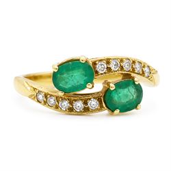 18ct gold emerald and diamond crossover ring, set with five round brilliant cut diamonds a...