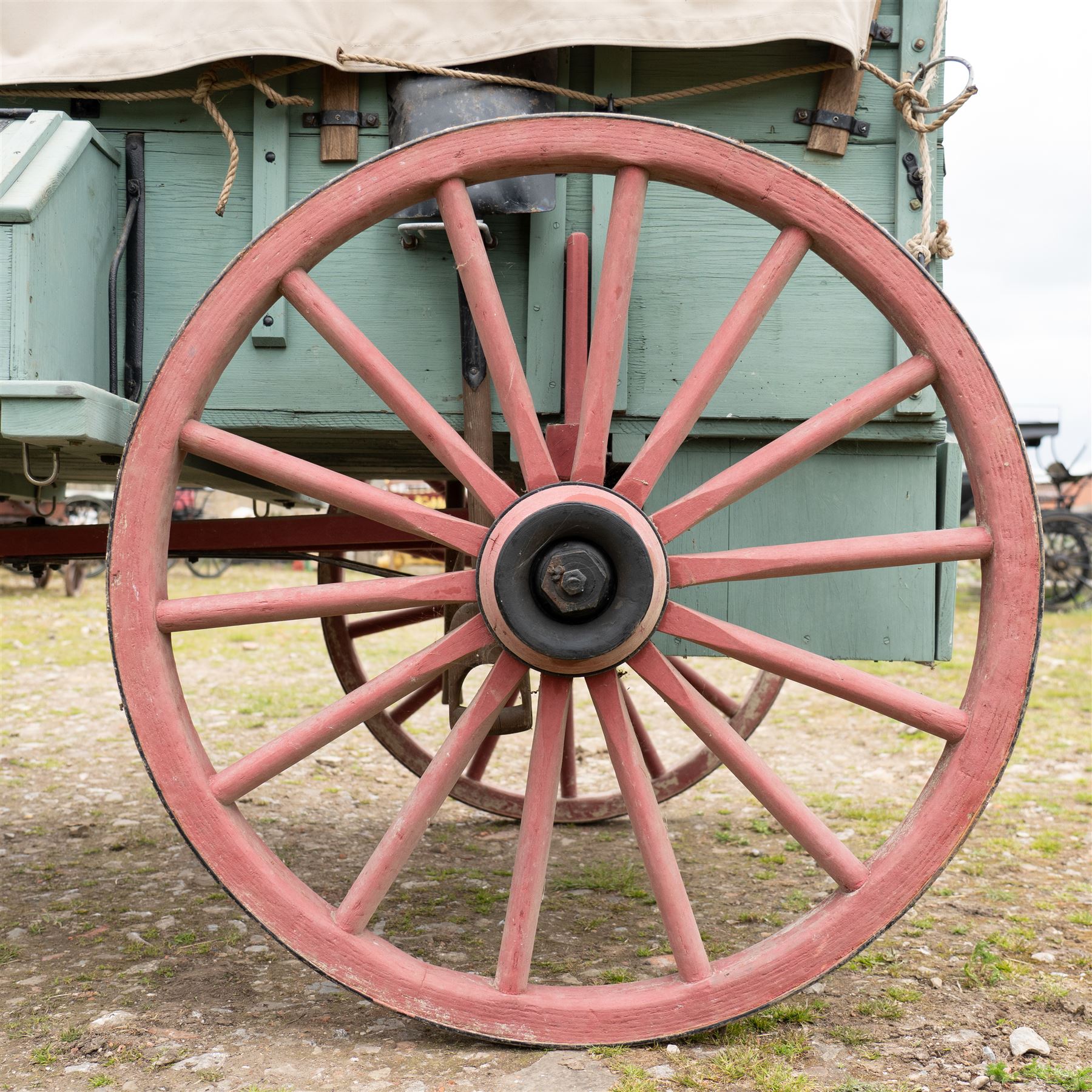 Western Covered Chuck Wagon

A large four wheeled covered wagon of timber construction, painted pale green with red painted wooden spoked wheels and a cream canvas tilt over an arched frame. The wagon has a traditional box body with covered rear compartment, front driving position, underbody turntable steering and iron fittings throughout. Fitted with external equipment details including a side mounted barrel, lidded storage chest, rope tie downs, horseshoe fittings and rear storage box.

Features

• Pale green painted timber body
• Cream canvas tilt over arched frame
• Covered rear compartment
• Front driving position
• Side mounted barrel
• External lidded storage chest
• Rear storage box
• Wooden spoked wheels
• Iron tyres
• Underbody turntable steering
• Rope tie downs
• Horseshoe fittings
• Iron hardware and brackets
• Brass restoration plaque to rear

Dimensions:
Overall length: 335 cm
Width: 170 cm
Height: 275 cm

Wheel Diameters:
Front wheels: 92 cm
Rear wheels: 112 cm

Seating:
Driver: 1
Passenger: Rear covered compartment