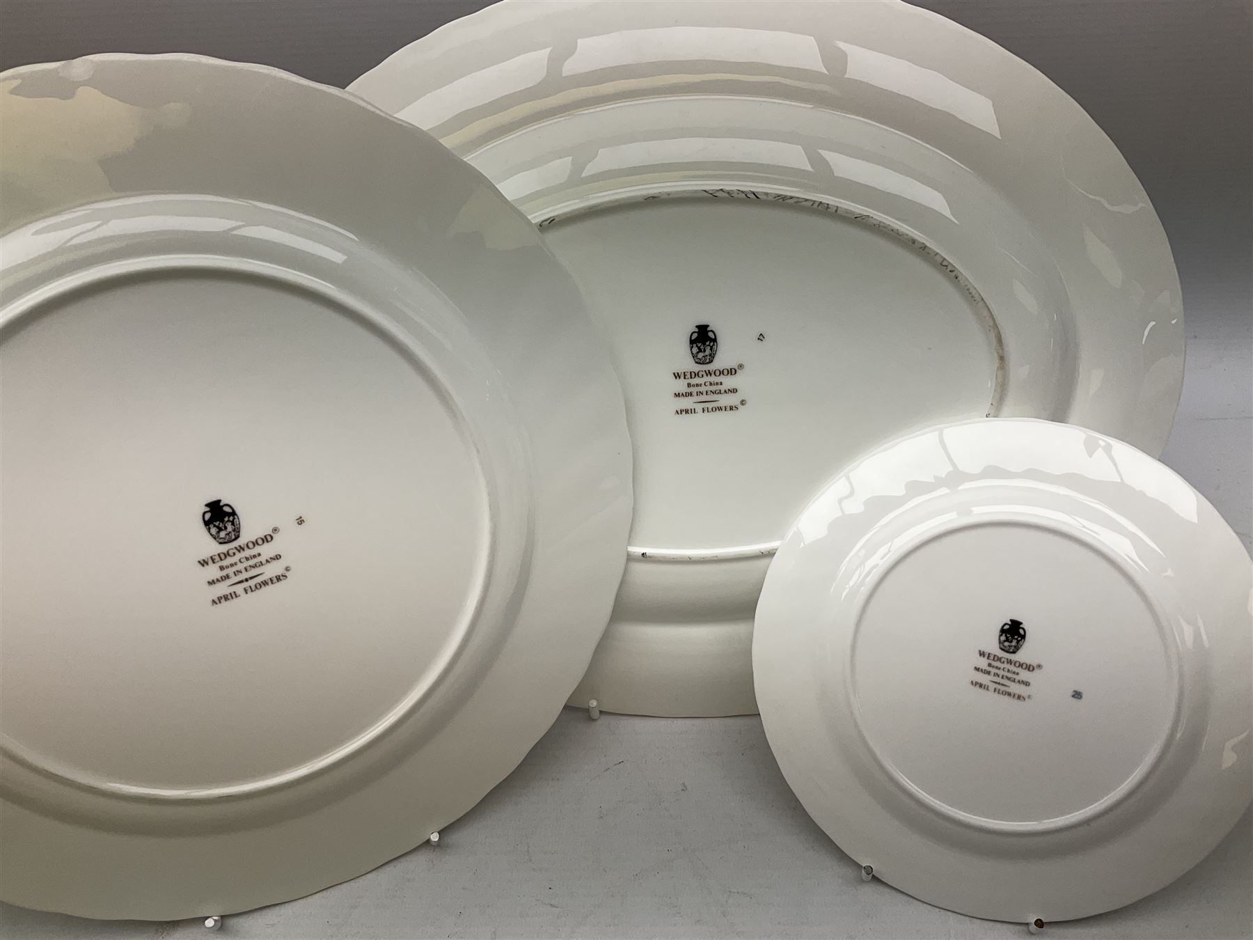 Wedgwood tea and dinner service decorated in the ‘April Flowers’ pattern, to include nine bowls, seven teacups and saucers, three coffee cups and saucers, sauce boat and stand, lidded tureen, covered sucrier and another smaller, oval serving plate, twelve side plates, teapot, four dinner plates, jug and shallow bowl