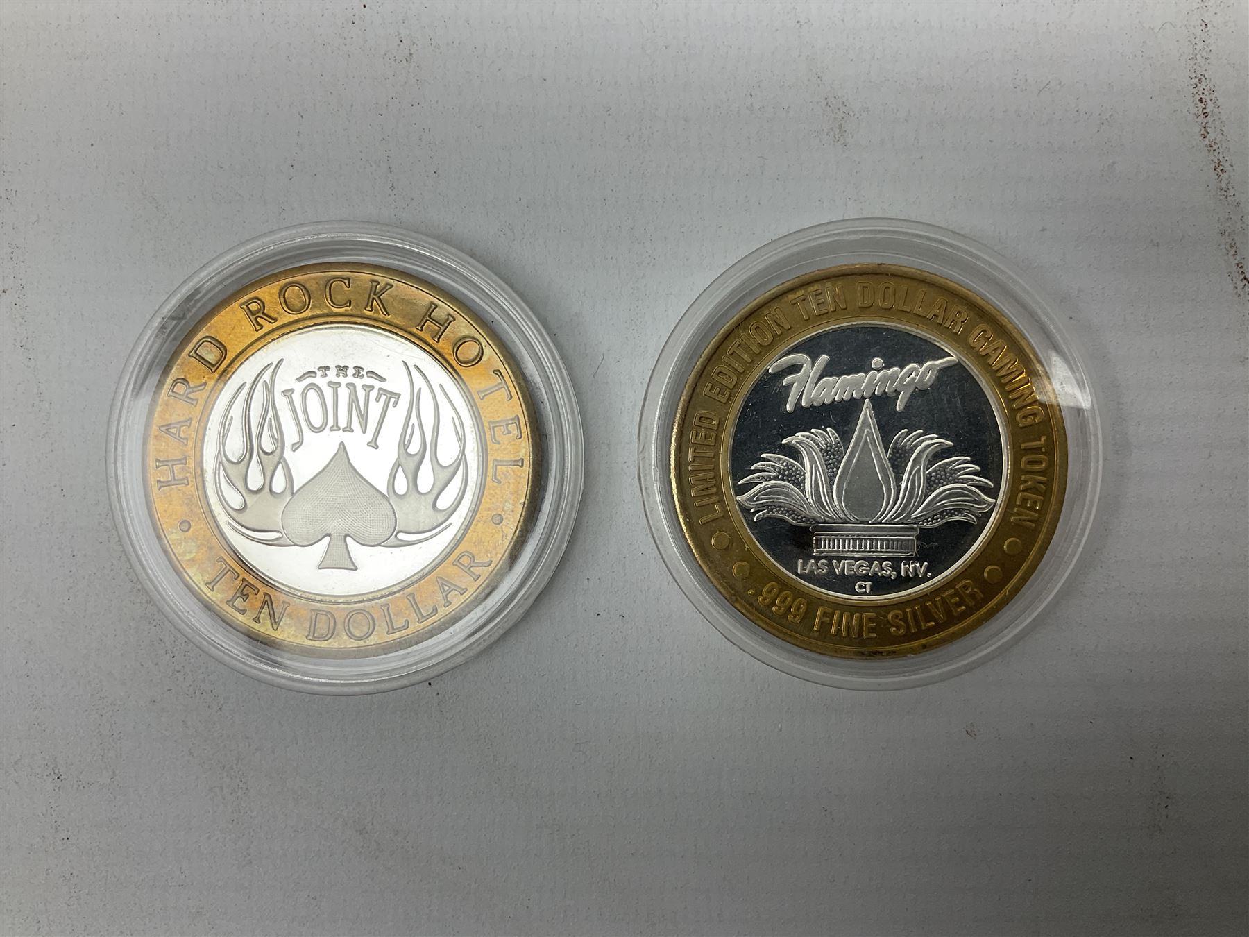 Eight Las Vegas limited edition ten dollar casino silver strike gaming tokens, consisting of a fine silver centre with brass outer ring (8)