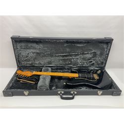 Copy of a Fender Stratocaster electric guitar in black with Wilkinson bridge, lock-in tuners, synchronised tremolo and various patent numbers; L99cm; in hard carrying case with strap and digital tuner