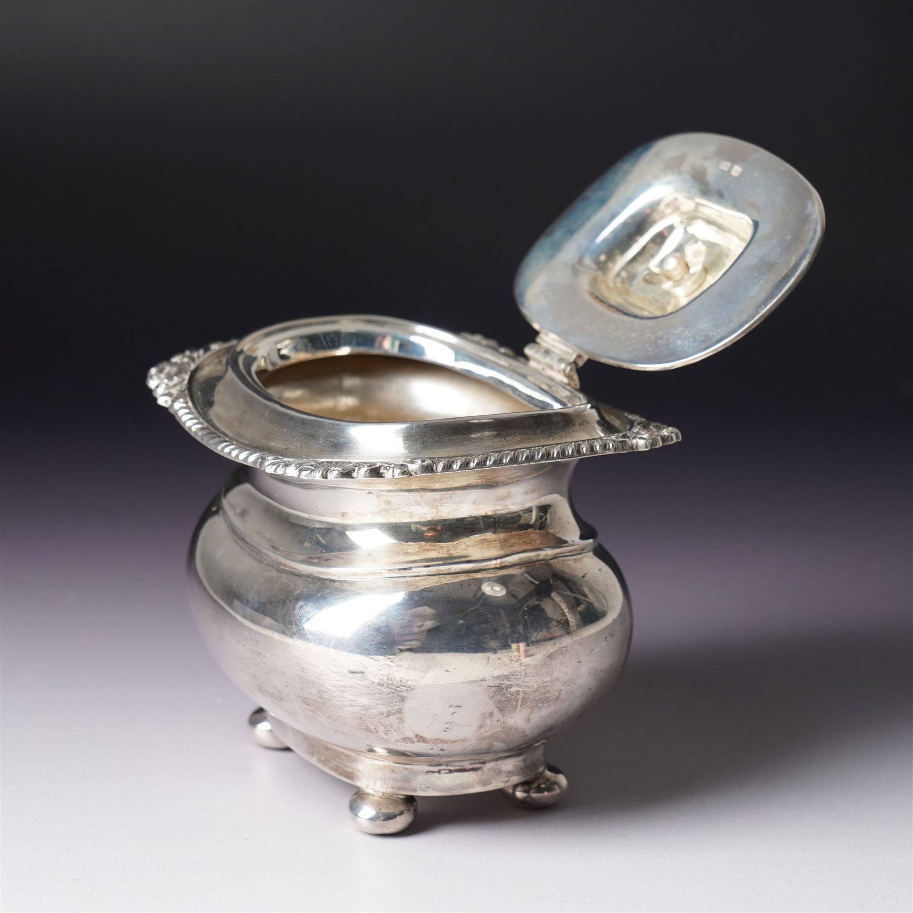 Edwardian silver tea caddy with hinged lid, ebonised lift and gadrooned edge on compressed bun feet Sheffield 1910 Maker Harrison Bros. and Howson