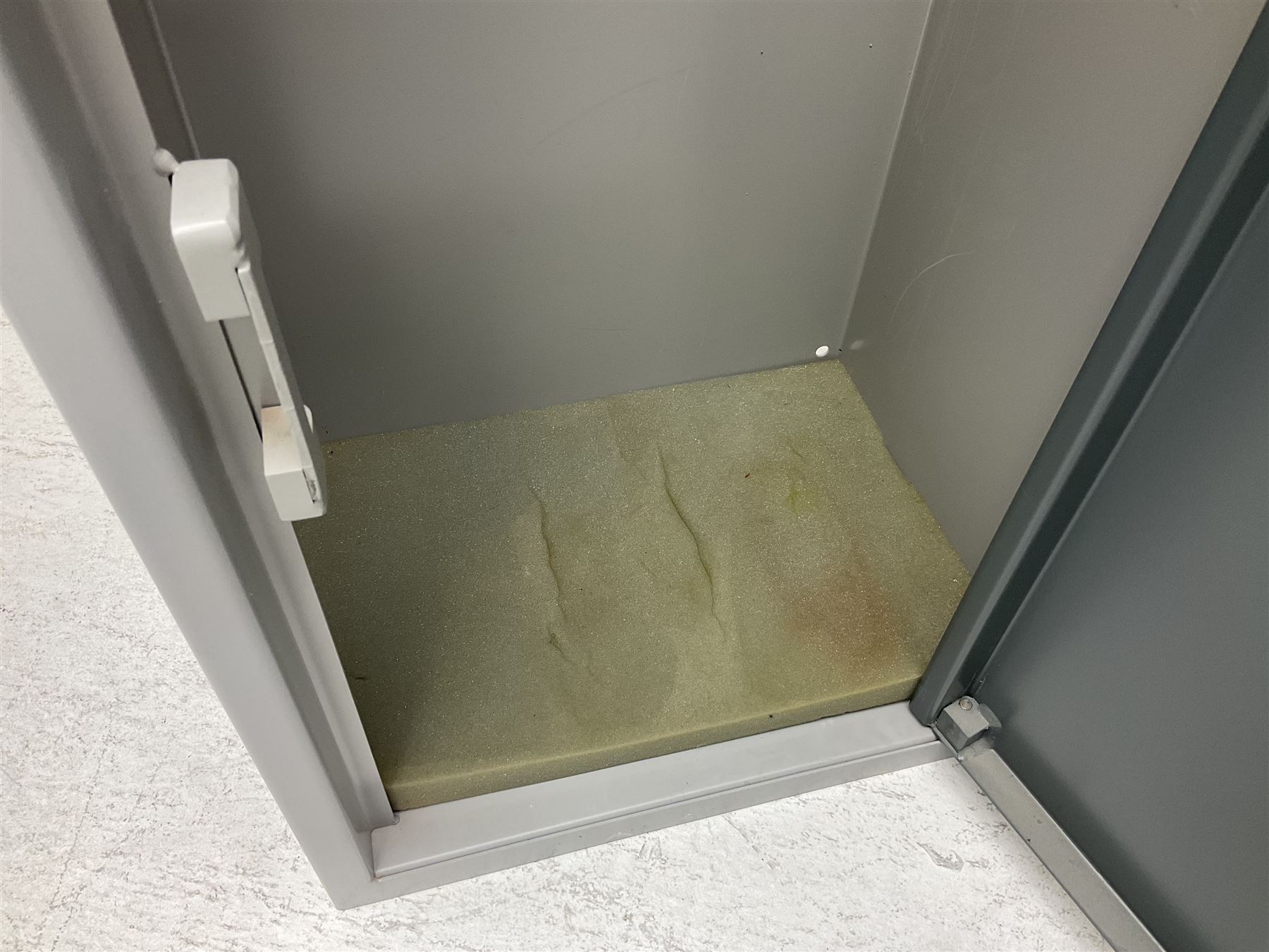 Two-tone grey steel wall-mounting gun cabinet by Sambell Engineering to accommodate six guns with fixed shelf over, gun space int. H132cm W36.5cm D23.5cm, the single double-locking door with two sets of keys, ext. H154cm W37cm D27cm