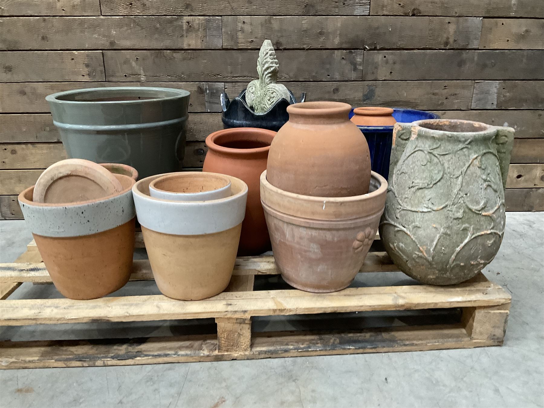 A quantity of various terracotta and glazed planters