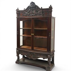 Large and impressive 19th century heavily carved mahogany display cabinet, the ornate pedi...