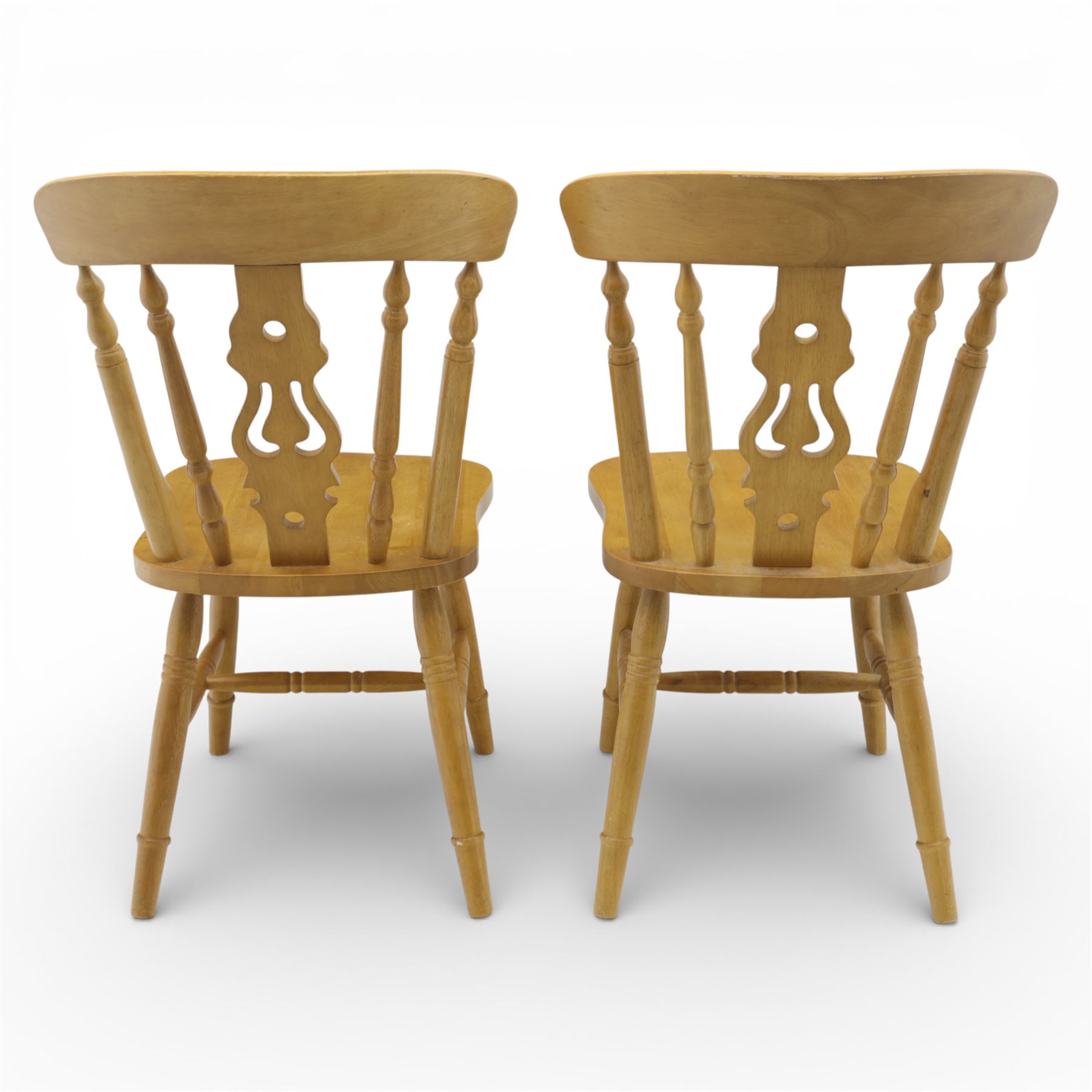 Solid oak dining table and set of seven pine farmhouse chairs including two carvers, rectangular top with tongue and groove style finish, supported a 'H' stretcher with square chamfered legs, pine farmhouse chairs with central splat and turned legs