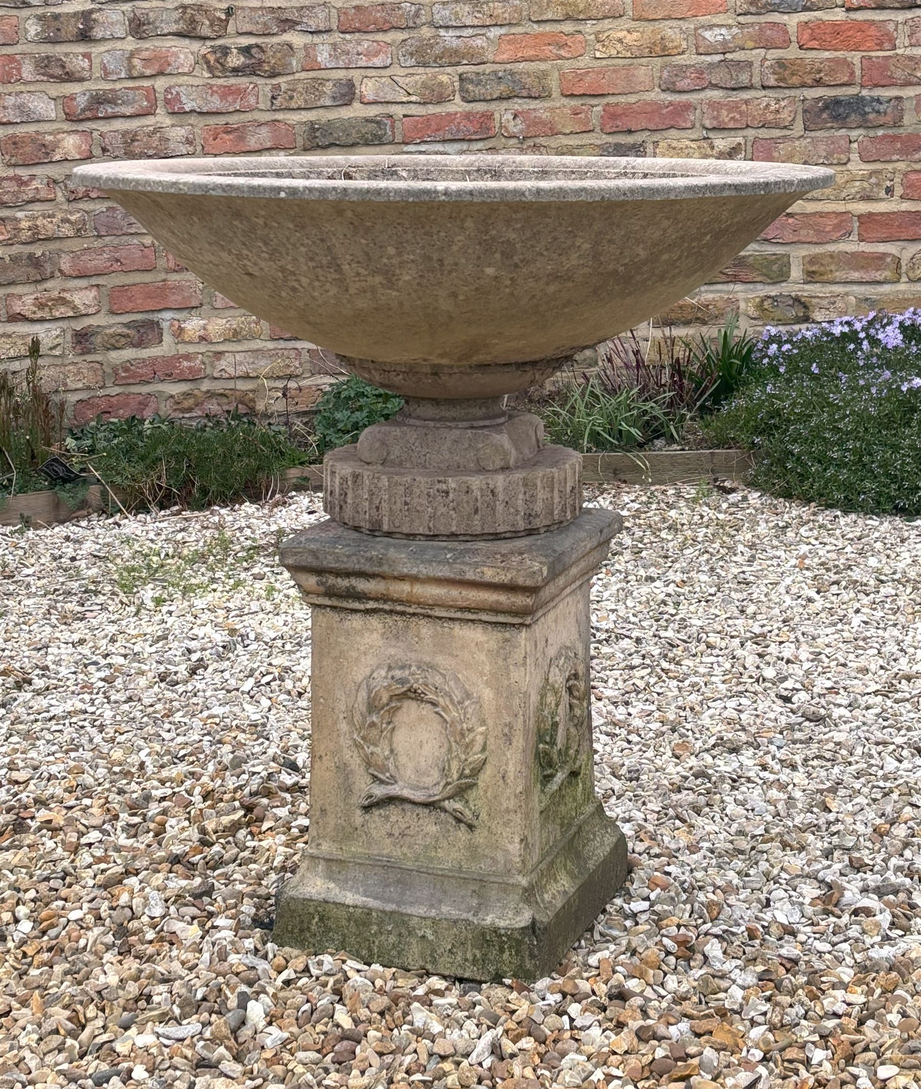 Reconstituted stone shallow urn / bowl planter, raised on a scrolled and fluted base. H43cm, D87cm. - COLLECTION BY APPOINTMENT FROM: The White House, Thirsk Road, Easingwold, York, YO61 3NF - CALL 01723 507111 TO ARRANGE