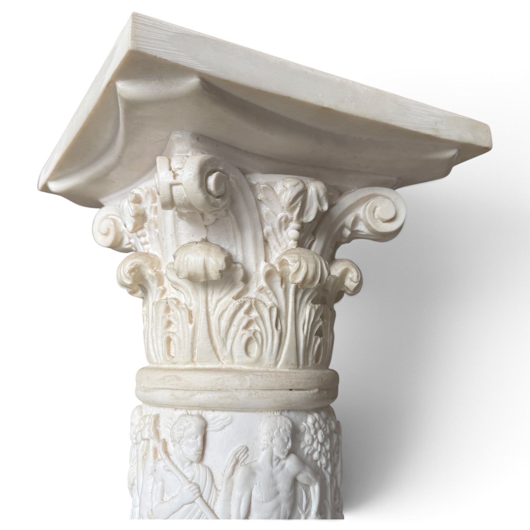 Neoclassical design composite column, square top over composite Ionic and Corinthian capital, the pedestal decorated with hunting and religious procession scenes, waisted and foliate socle on square base