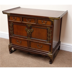  Chinese hardwood low cabinet, metal strapping, three short and two long drawers, two cupboard doors, bracket supports joined by sledge feet, W78cm, H64cm, D45cm  