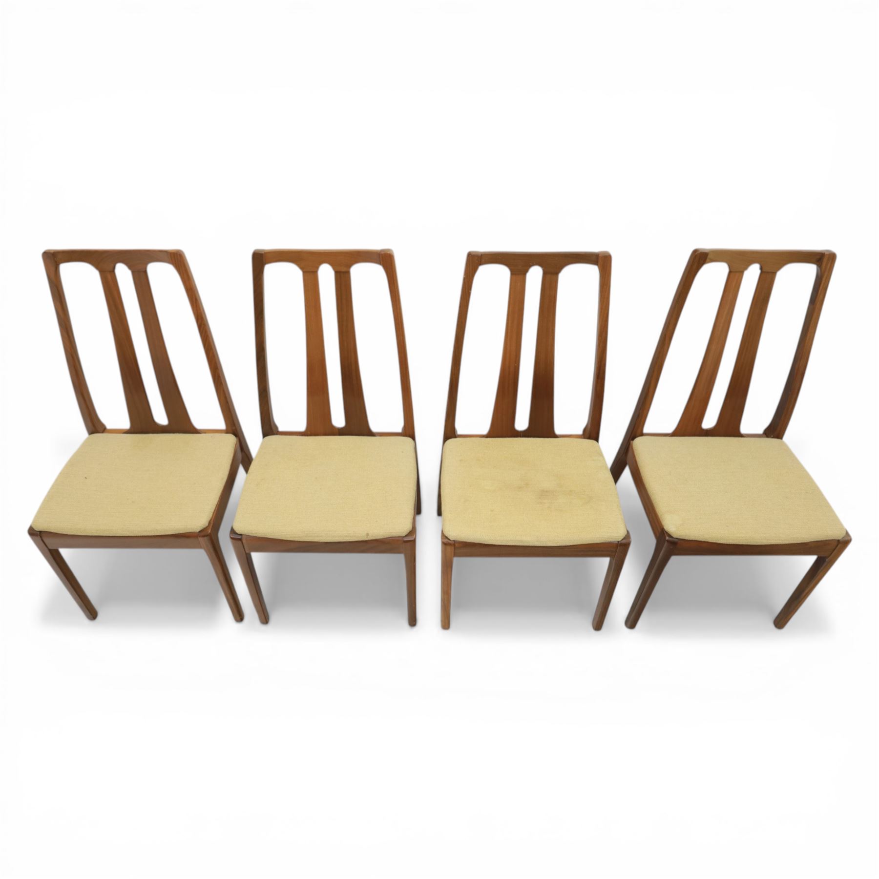 Nathan - teak drop leaf dining table and four Nathan dining chairs, the rectangular top with rounded corners fitted with twin hinged drop leaves and gate legs, extended to form an oval table 174cm in length, raised on square section supports united by stretchers, the chairs with teak frames and padded beige upholstered seat (H 96cm, W 48cm)