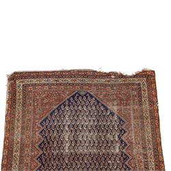 West Persian Kurdish vintage carpet, indigo field decorated with an all-over repeating boteh design arranged in diagonal rows framed by angular spandrels and enclosed by multiple geometric borders in a palette of indigo blue, madder red, soft green and ivory