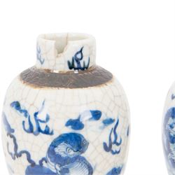 Pair of 20th century Chinese crackle glaze vases, of baluster form, decorated with dogs of foo amongst clouds, H23cm