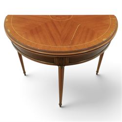 Regency revival mid 20th century walnut card table, demi lune form inlaid with boxwood, kingwood frieze with brass detail fold-over top with retractable back leg, revealing circular leather playing surface, circular tapering legs