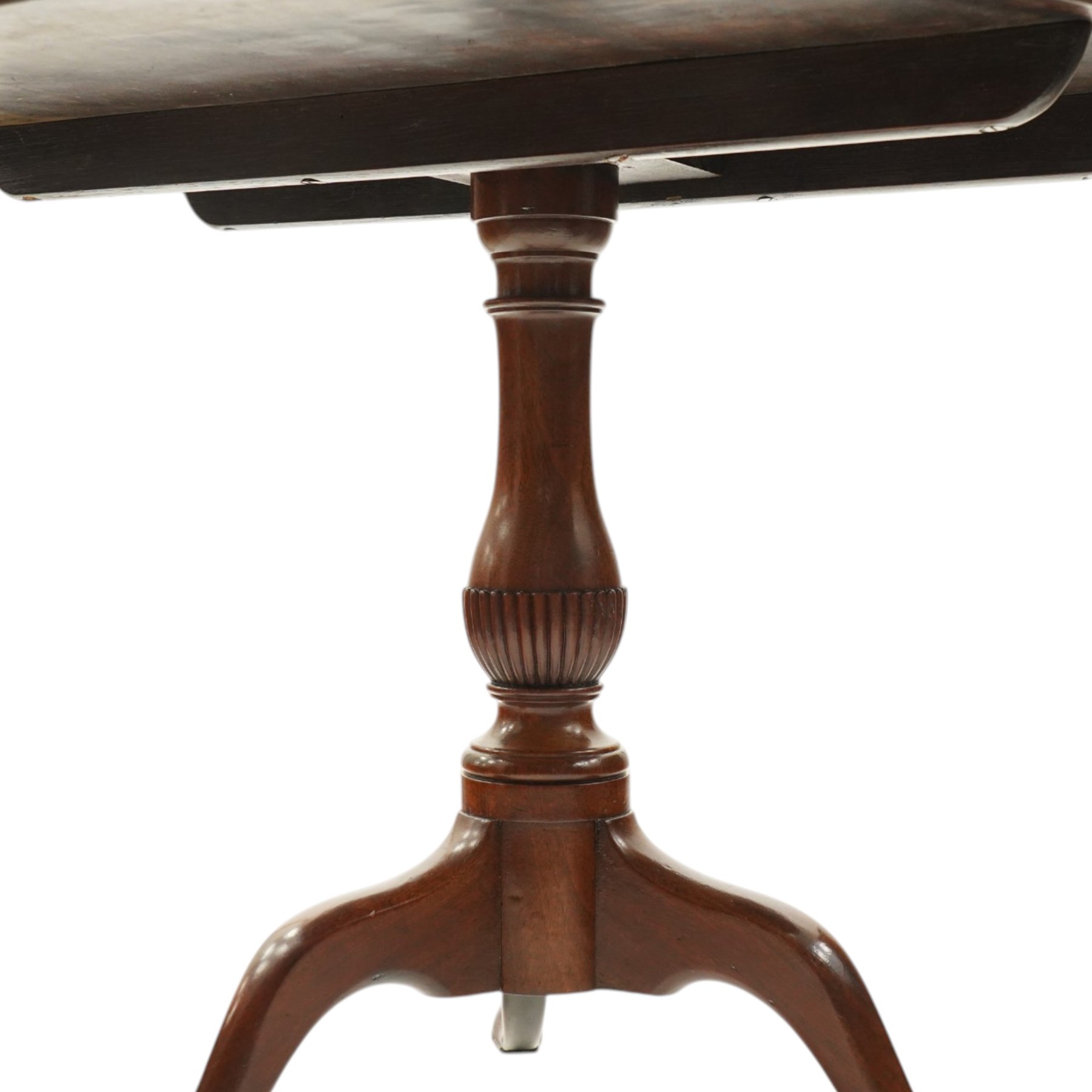 George III mahogany tilt-top tripod table, the circular figured top raised on a turned and tapering column with half-reeded lower section, over three splayed cabriole legs terminating in pad feet

Notes: several tables made by York cabinet maker John Walker for Harewood House share the same half reeded column, after the original drawing by Thomas Chippendale (c.f. The Life and Works of Thomas Chippendale, Christopher Gilbert, 1978, p.264)