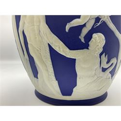 19th century Wedgwood dark blue dipped Jasperware Portland vase, of ovoid form with twin handles to shoulders and waisted neck, and flared rim, the body decorated with a continuous scene of classical figures in relief, the base decorated with portrait in relief, H26cm